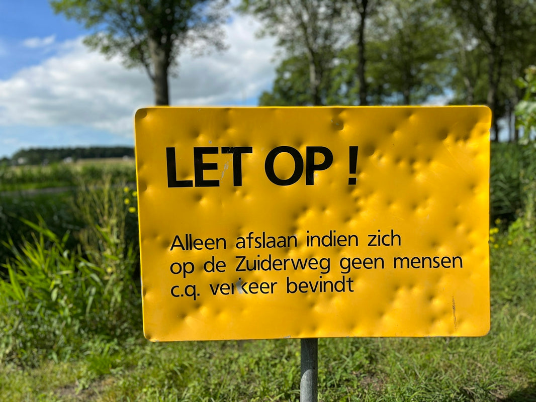 a yellow sign in a field