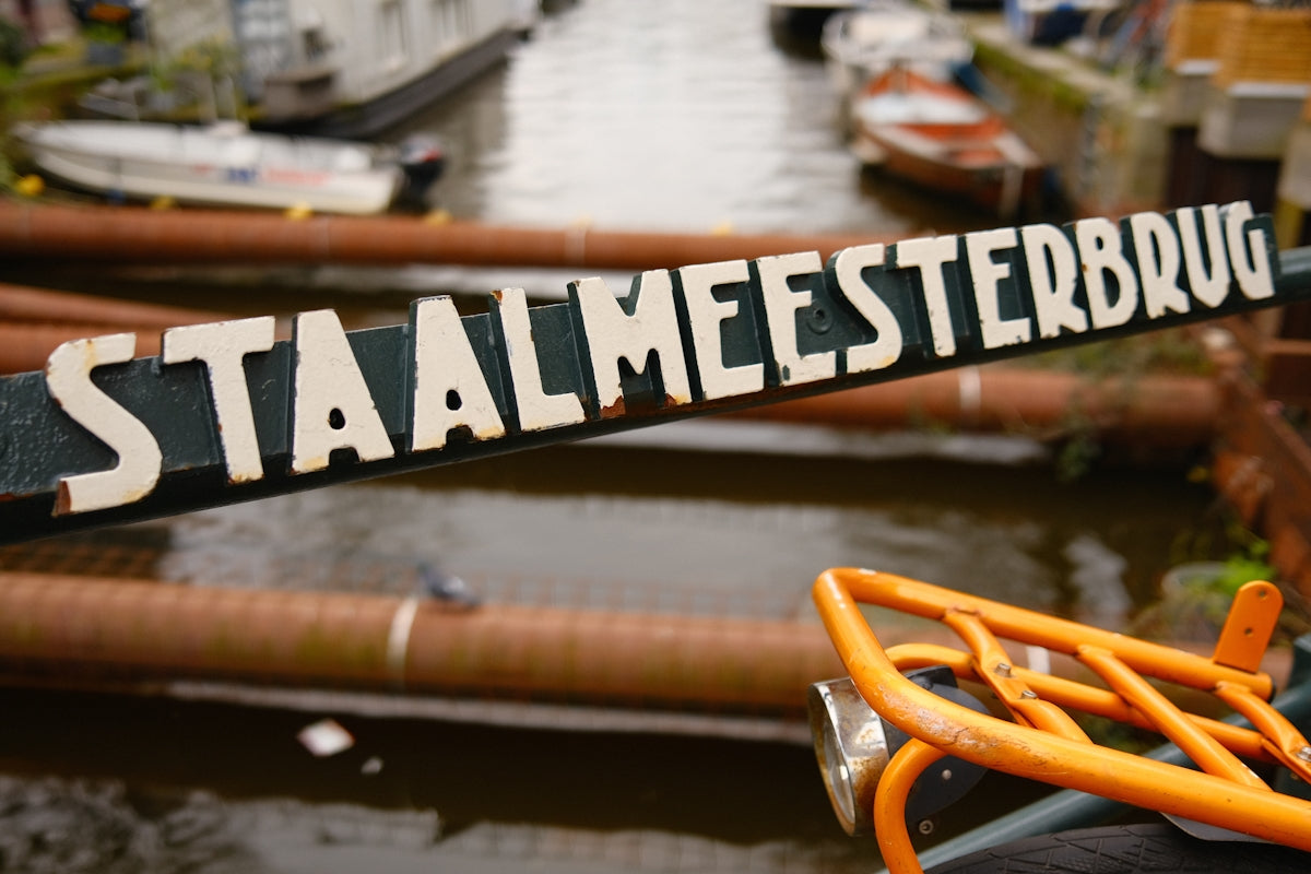 a close up of a street sign near a body of water