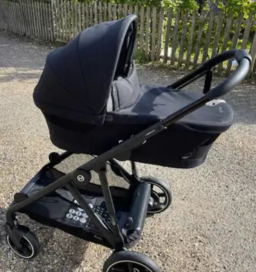 Black stroller with a sleek, modern design and soft fabric canopy.
