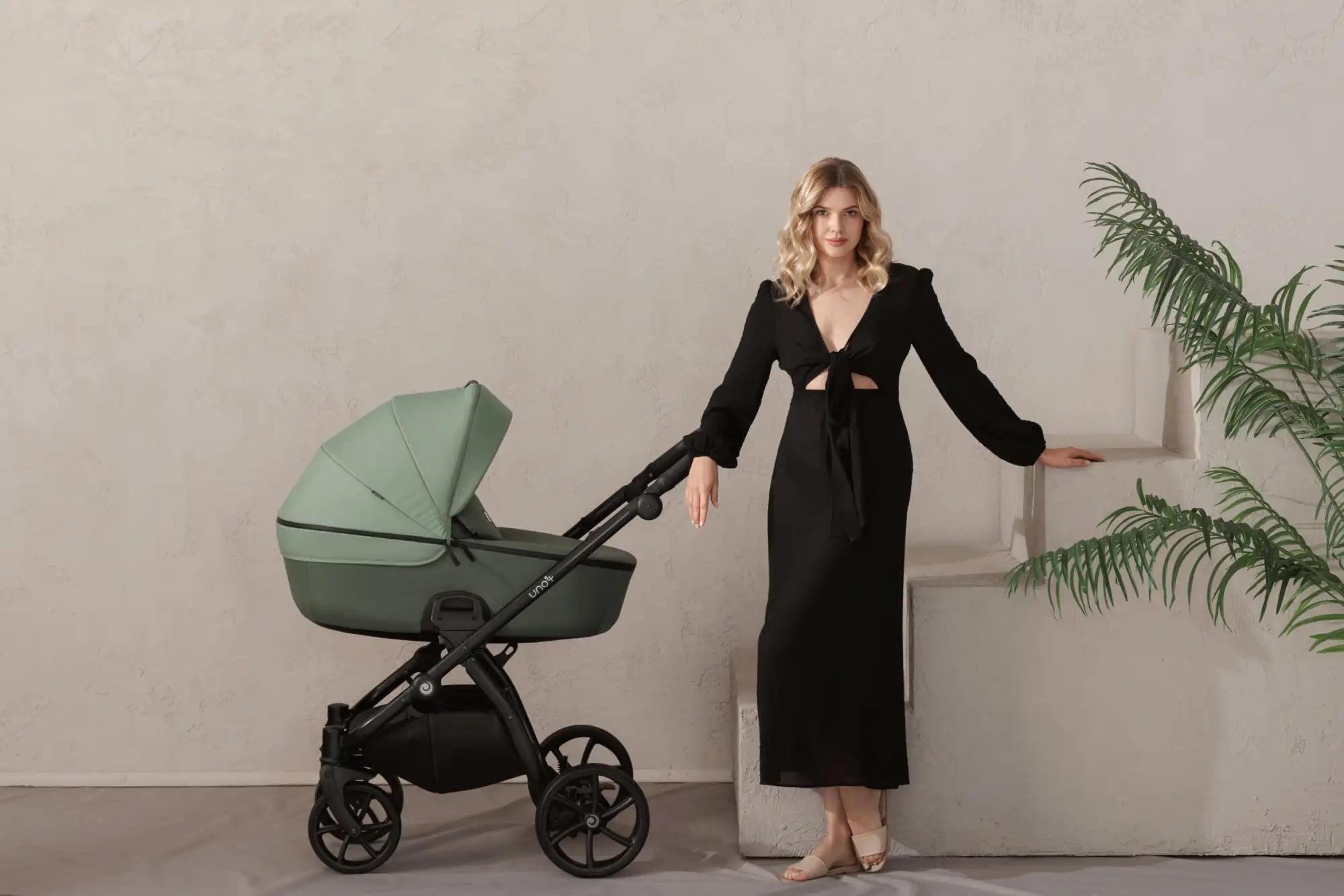 Mint green and black stroller with a sleek, modern design.